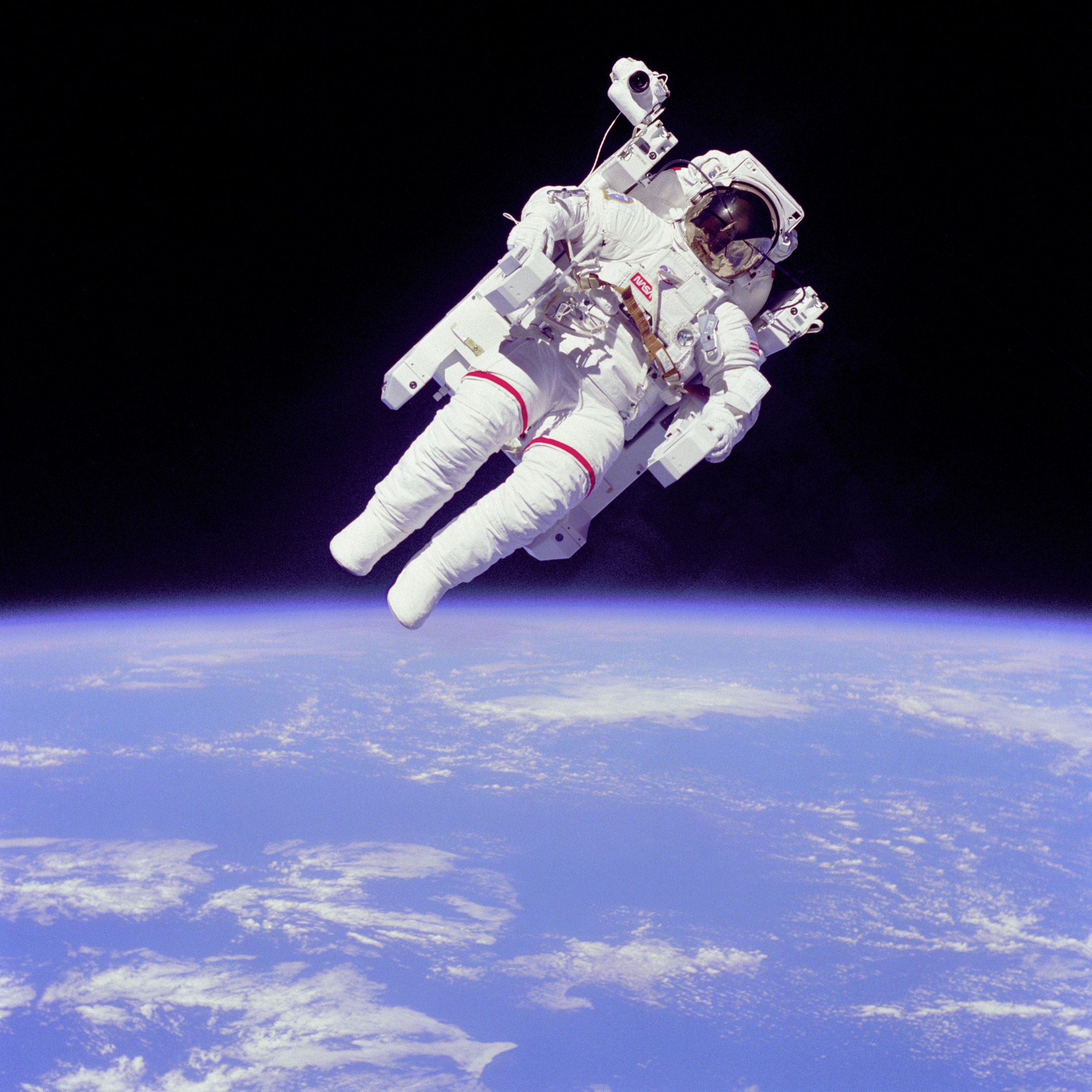 Astronaut floating in space above Earth